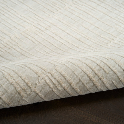 Beige textured rug with raised wavy stripe pattern, plush pile, laid on dark wood floor.