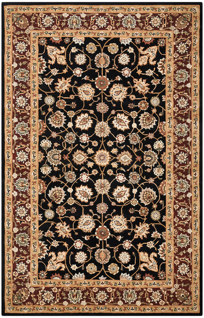 Rectangular oriental rug with black field, ivory-gold floral vines and medallions, red-brown border.