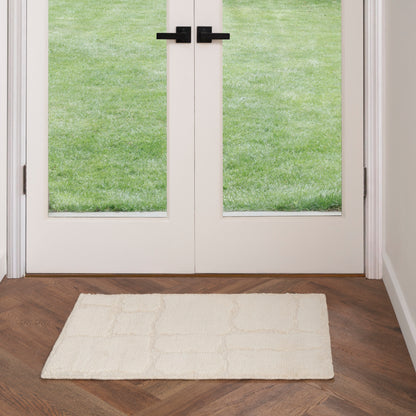 Cream rug on dark wood floor.