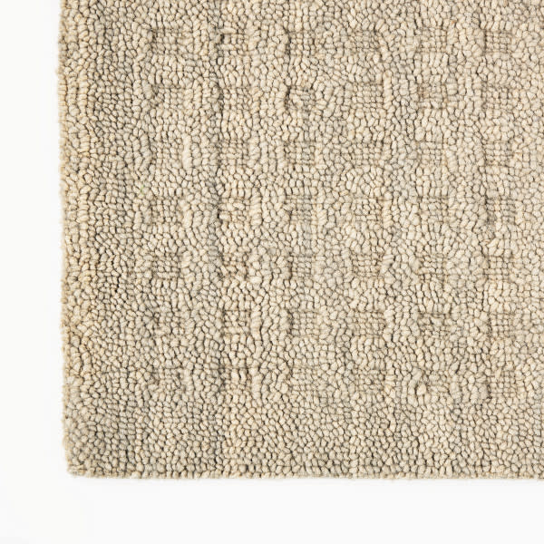 Smooth champagne beige rectangle over cream looped shag rug; warm modern home decor texture.
