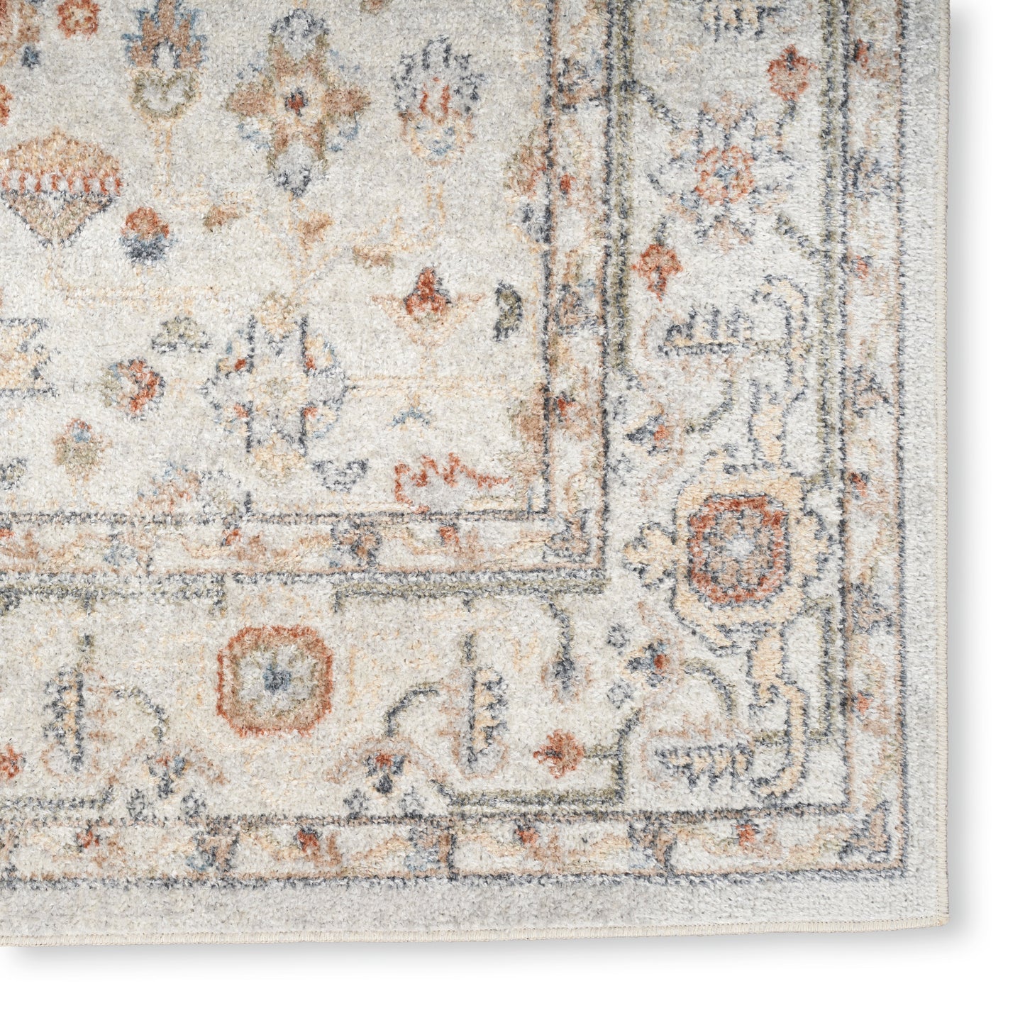 Cream Persian-style rug with blue and rust floral motifs and a decorative border; soft textured pile. Vintage 7' x 9'.