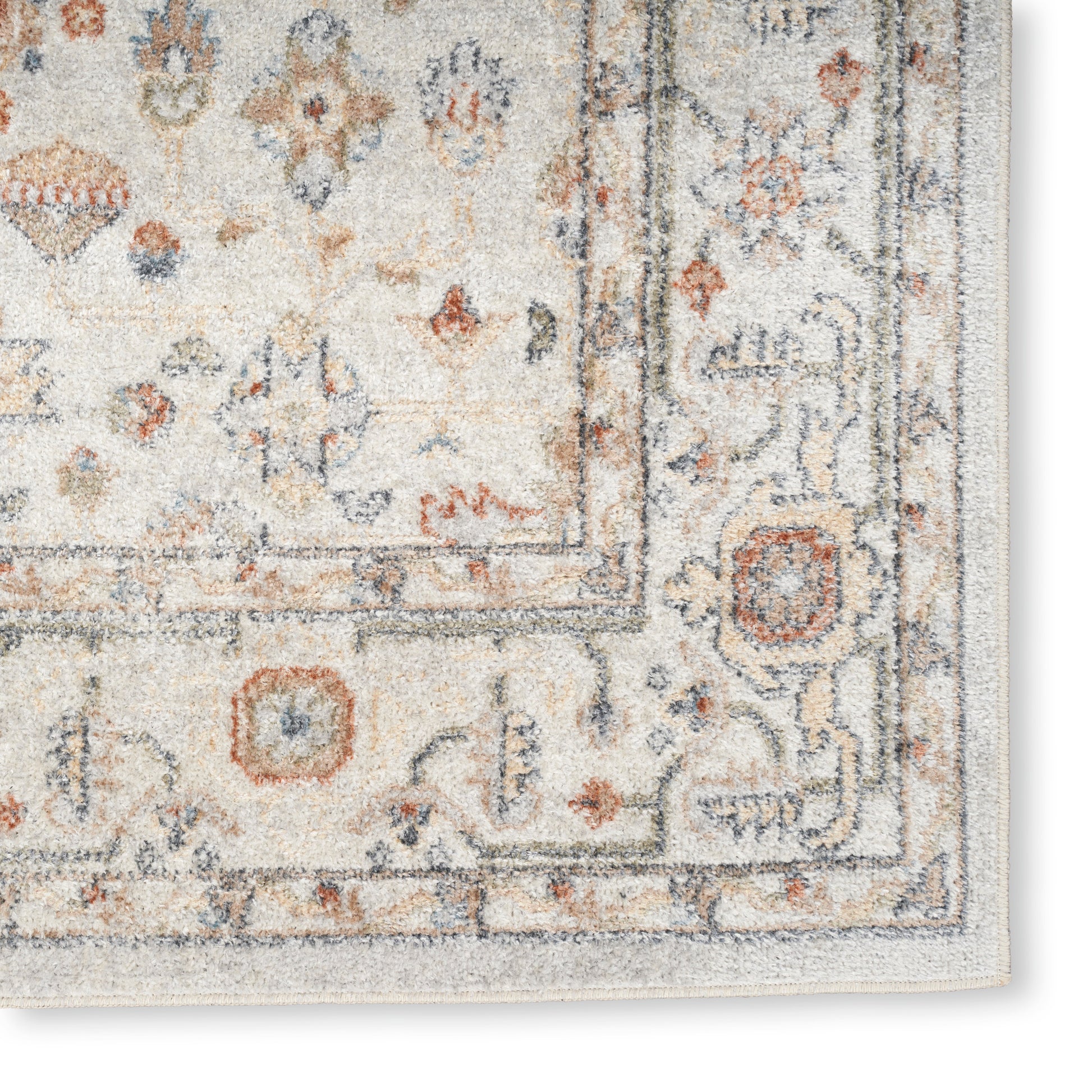 Cream Persian-style rug with blue and rust floral motifs and a decorative border; soft textured pile. Vintage 7' x 9'.