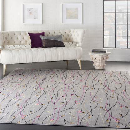 Light gray abstract area rug with black, magenta and gold vine-like lines in a modern living room setting.