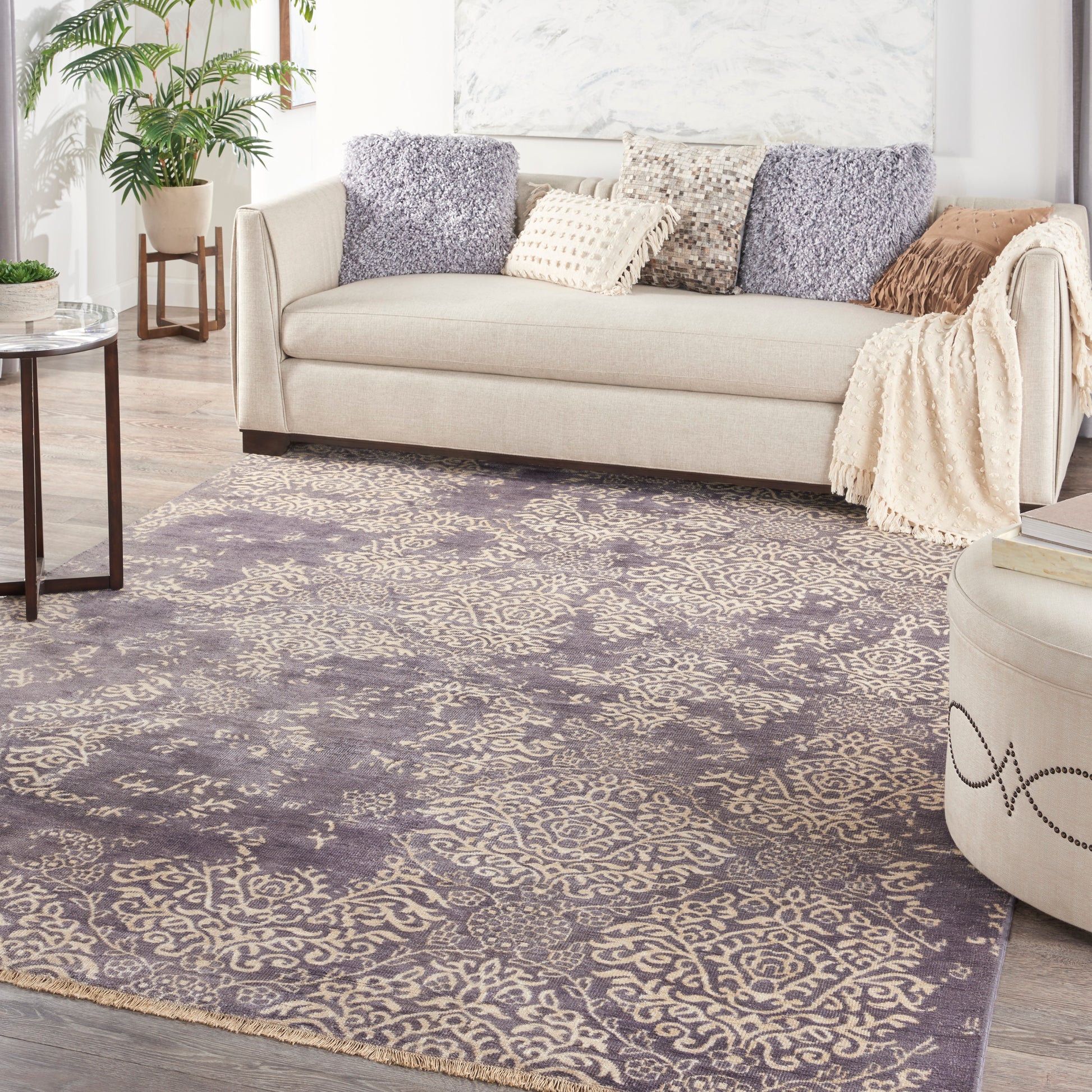 Ornate purple-beige vintage area rug in a bright living room.
