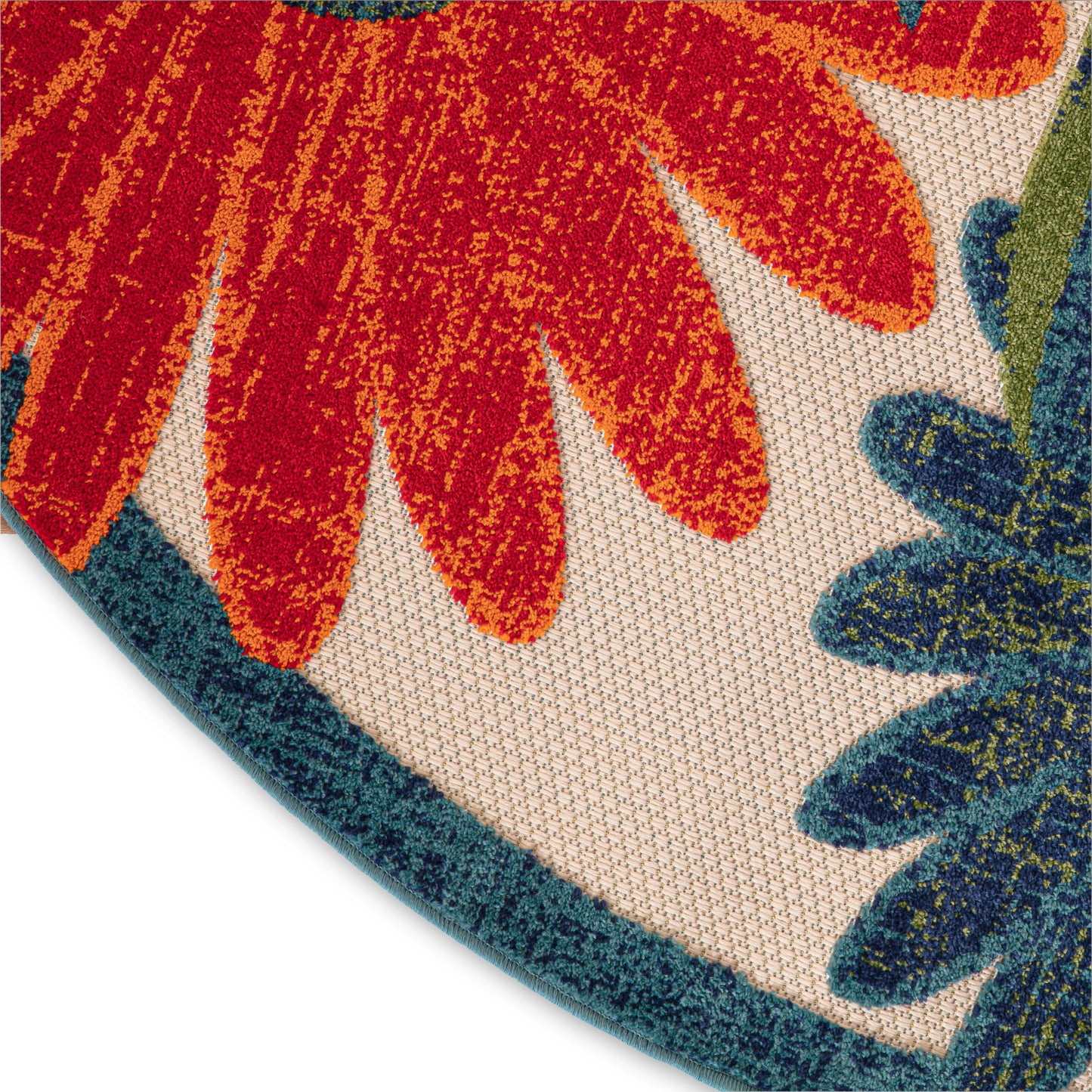 Round rug with bold floral pattern in red, orange, teal and navy; plush textured pile, vibrant and decorative.