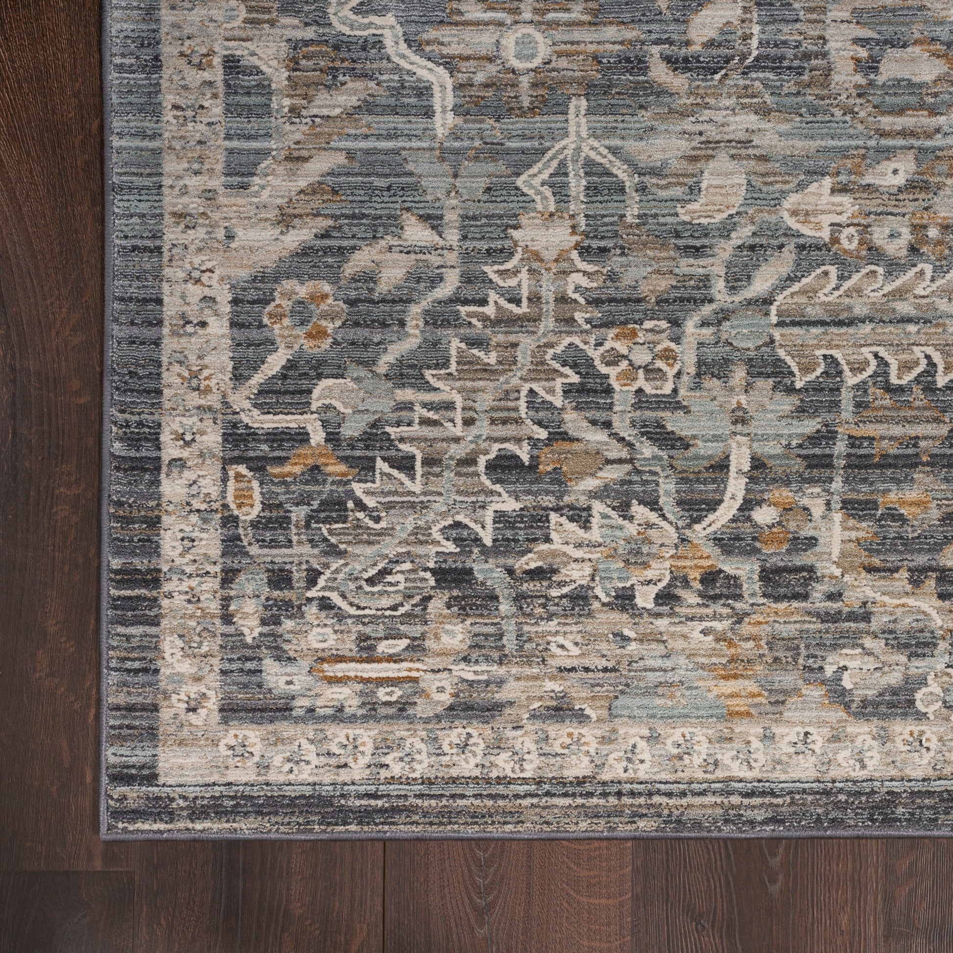 Blue-gray traditional runner rug with ivory border and floral vine pattern on dark wood floor, 10 ft long.
