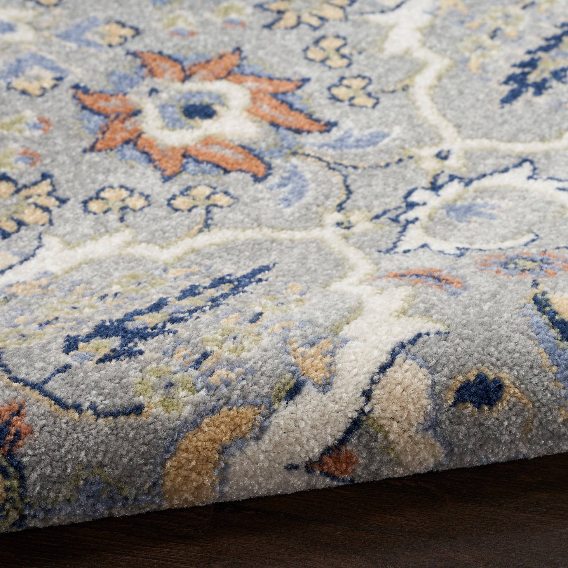Soft plush rug in light grey with blue, ivory & peach floral pattern; tufted, medium pile for living room decor