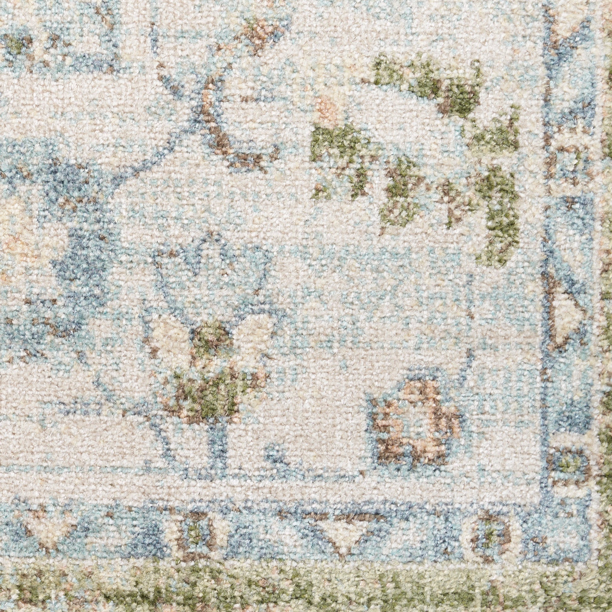 Pastel blue and cream oriental rug close-up with floral vines, woven texture, and decorative border.