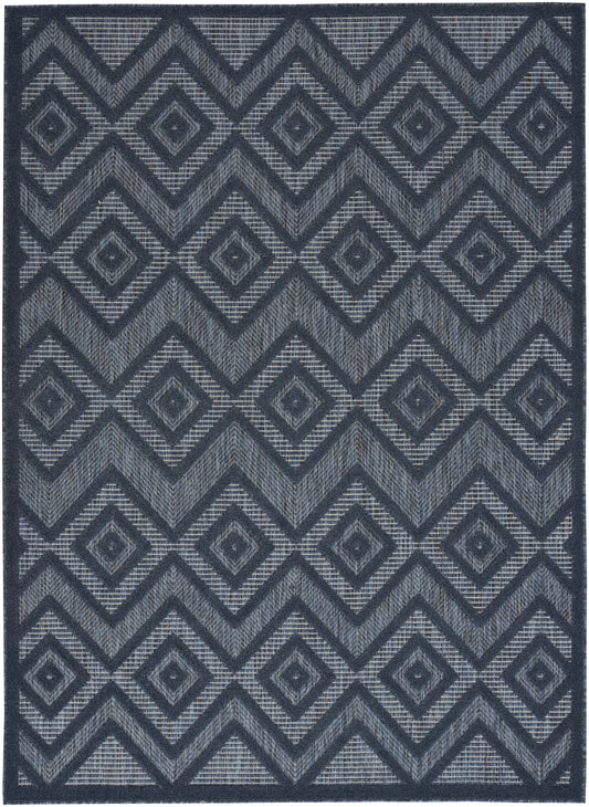 Navy blue rectangular area rug with repeating diamond and chevron geometric pattern in light gray, woven texture.