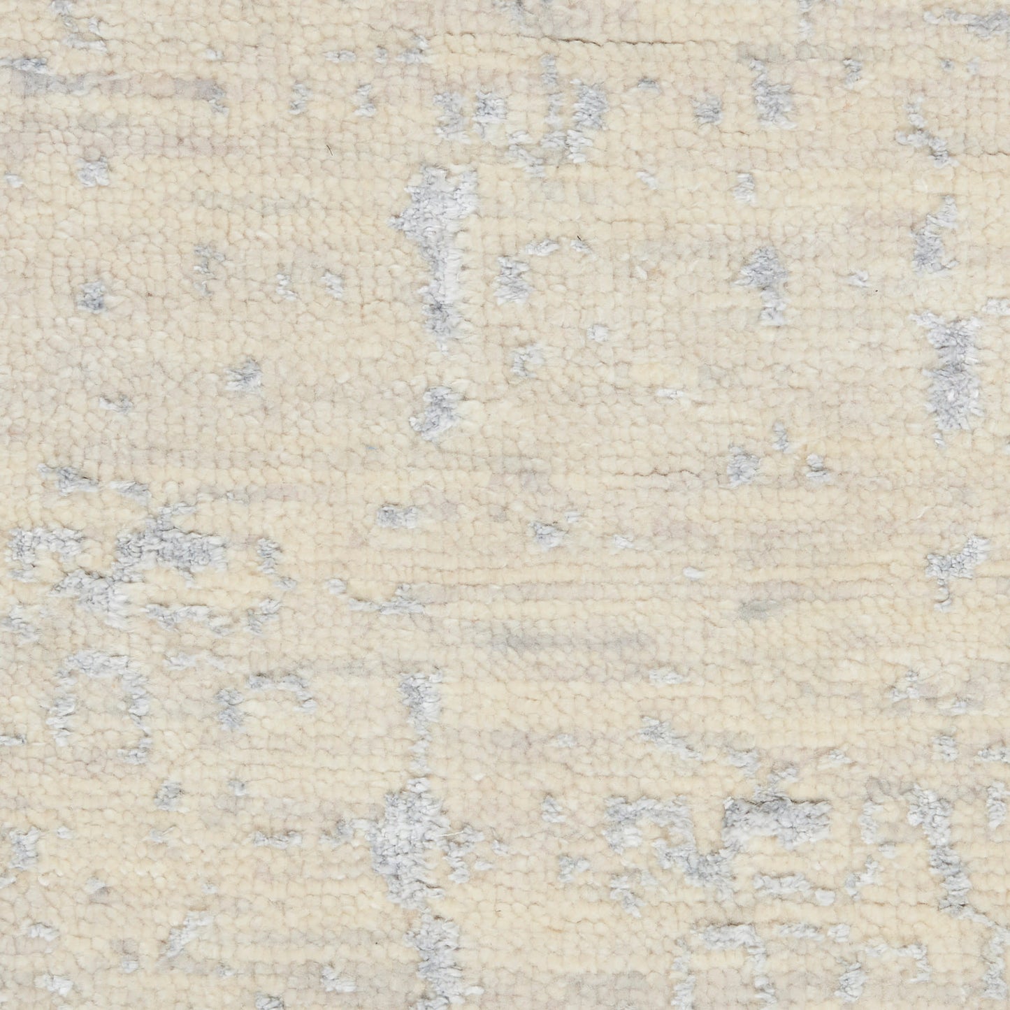 Beige cream rug with soft gray abstract pattern and plush pile.