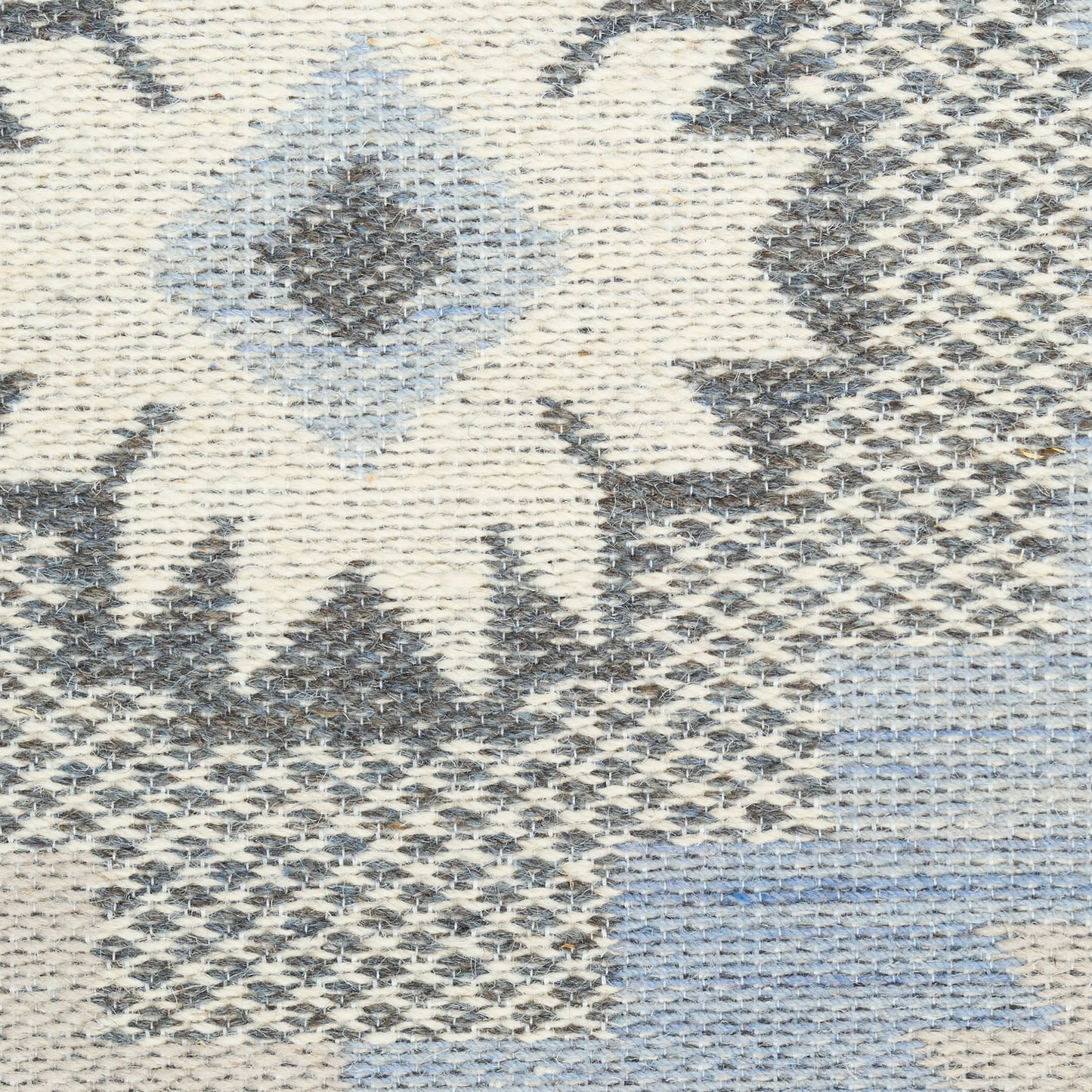 Woven kilim-style rug with ivory, grey and pale blue geometric diamonds and chevrons.