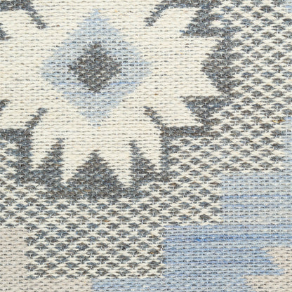 Woven kilim-style rug with ivory, grey and pale blue geometric diamonds and chevrons.