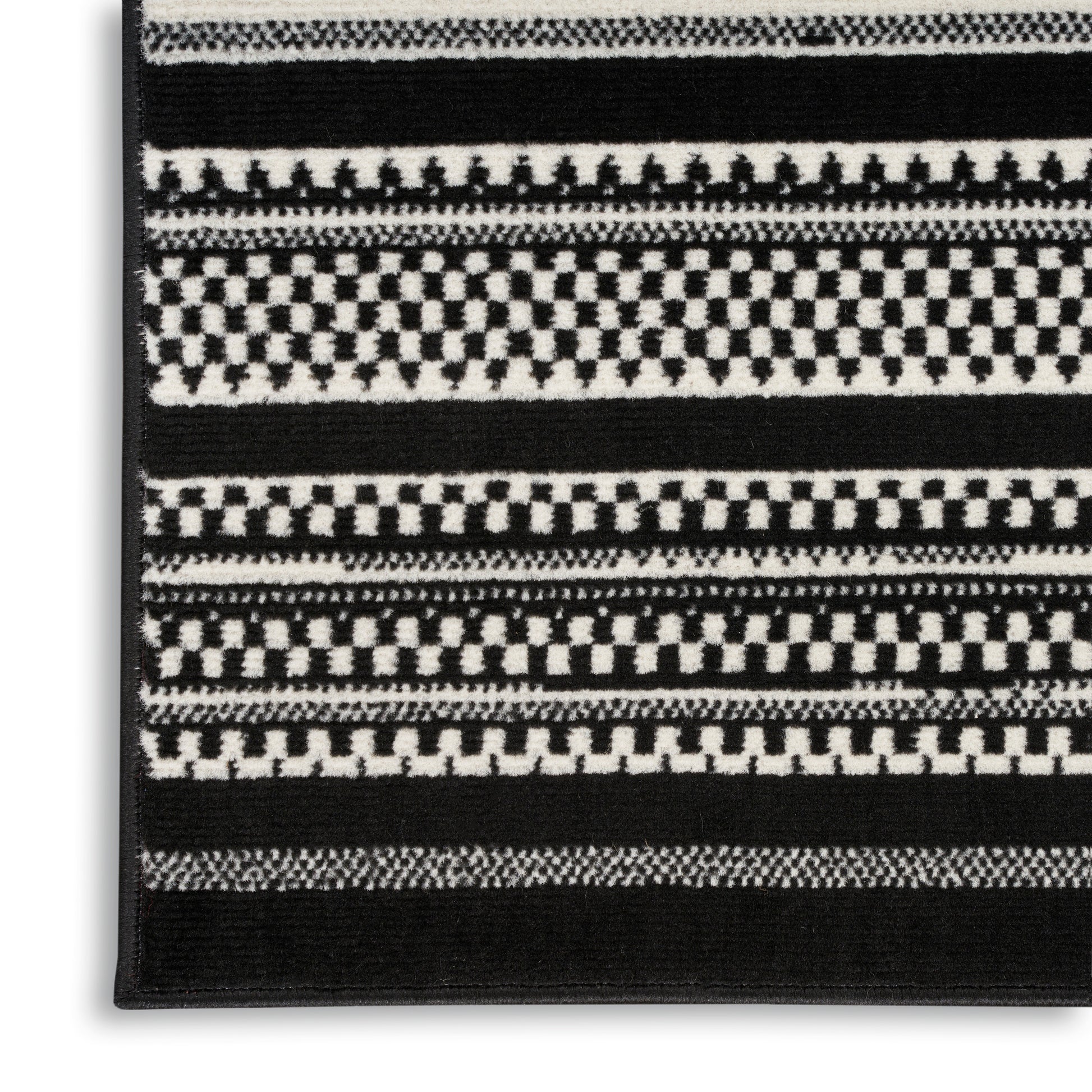 Black-and-white woven rug with checkerboard stripes & geometric bands; rectangular, modern home decor.