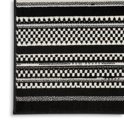 Black-and-white woven rug with checkerboard stripes & geometric bands; rectangular, modern home decor.