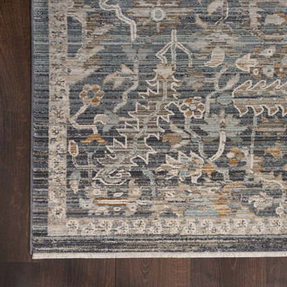Traditional oriental rug in navy with ivory floral vines, light border, beige accents, fringe edge on dark wood floor.