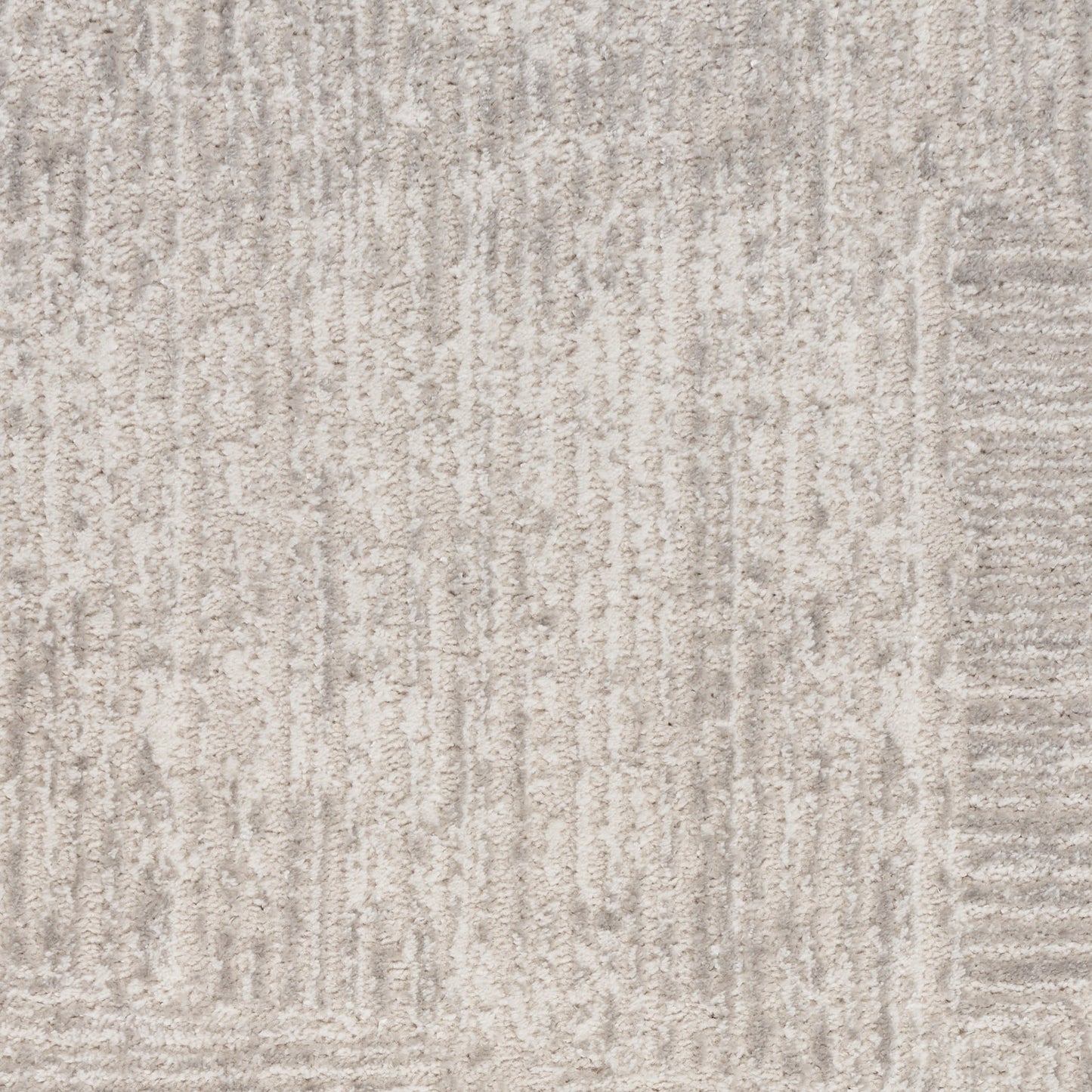 Light grey textured rug with subtle vertical lines and a soft pile.