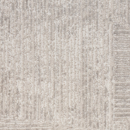 Light grey textured rug with subtle vertical lines and a soft pile.