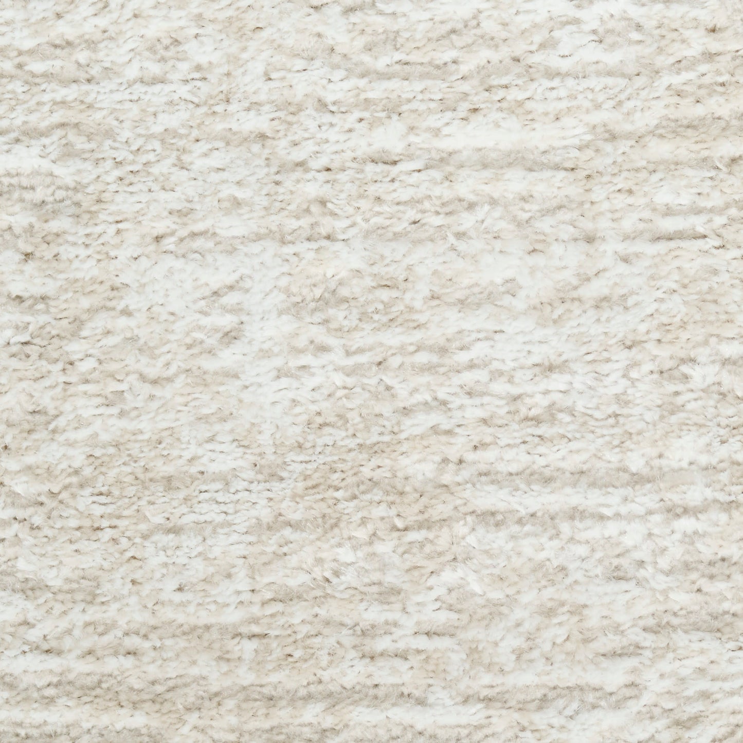 Cream shaggy rug texture with plush synthetic fibers in beige tones.