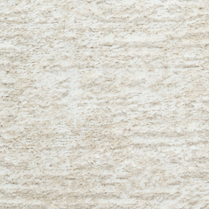 Cream shaggy rug texture with plush synthetic fibers in beige tones.