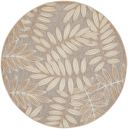 Round rug with beige botanical leaf pattern on gray woven background & beige border; textured, coastal style.