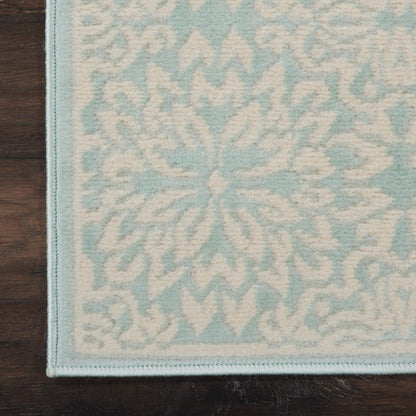Light blue & ivory floral patterned hallway runner with a stitched blue border on a wooden floor.