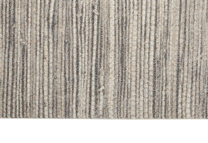 Beige, taupe and gray striped textured area rug close-up with a soft pile.