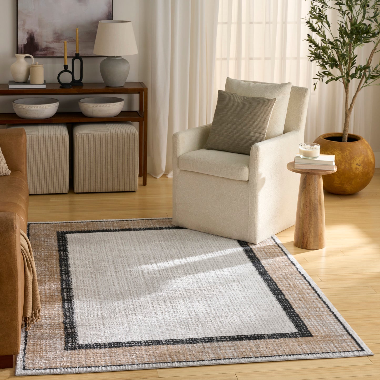 Beige rug with a black border in a sunlit living room.