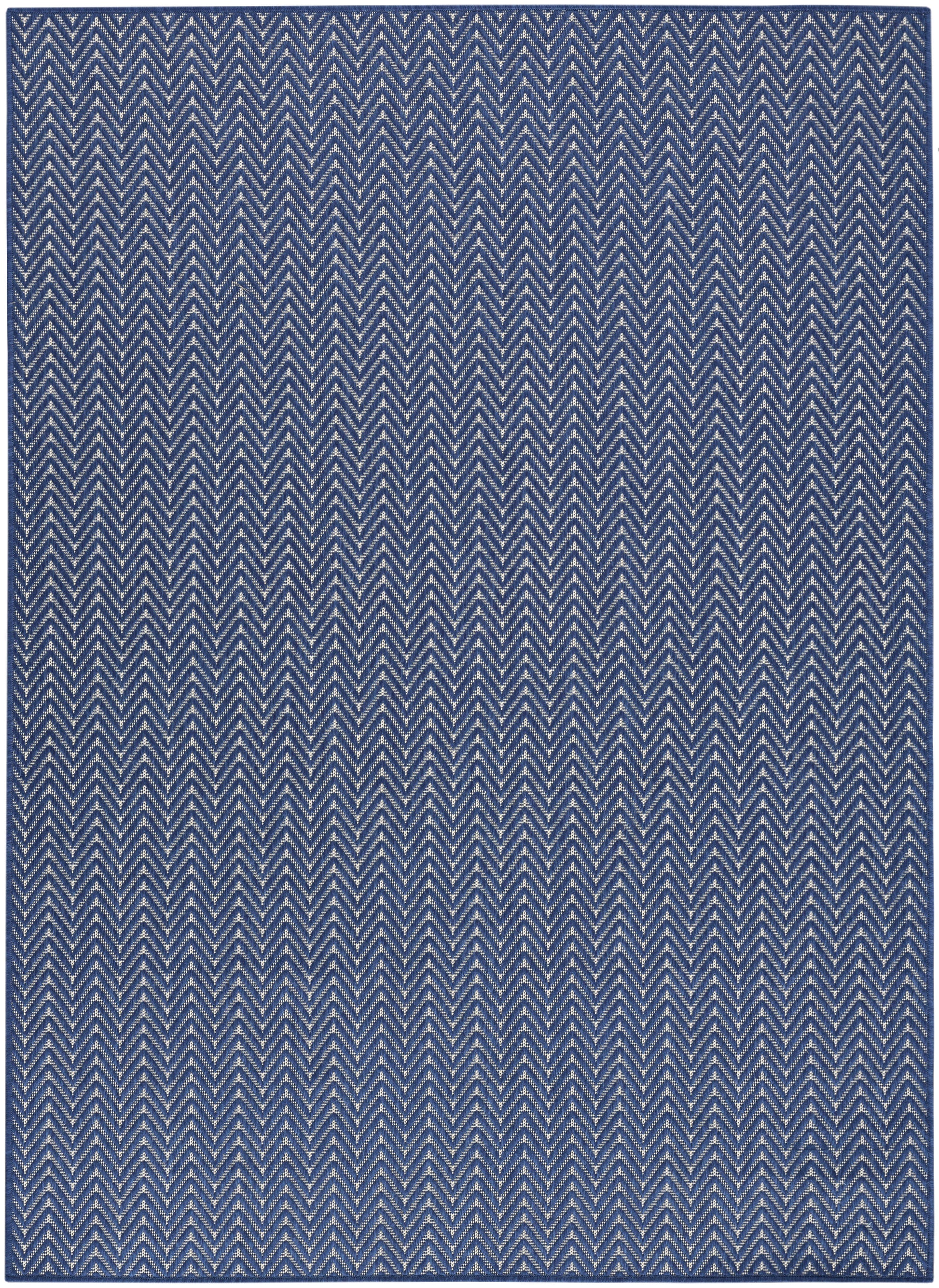 Blue rug with white chevron zigzag pattern, woven texture, rectangular shape, modern coastal style.