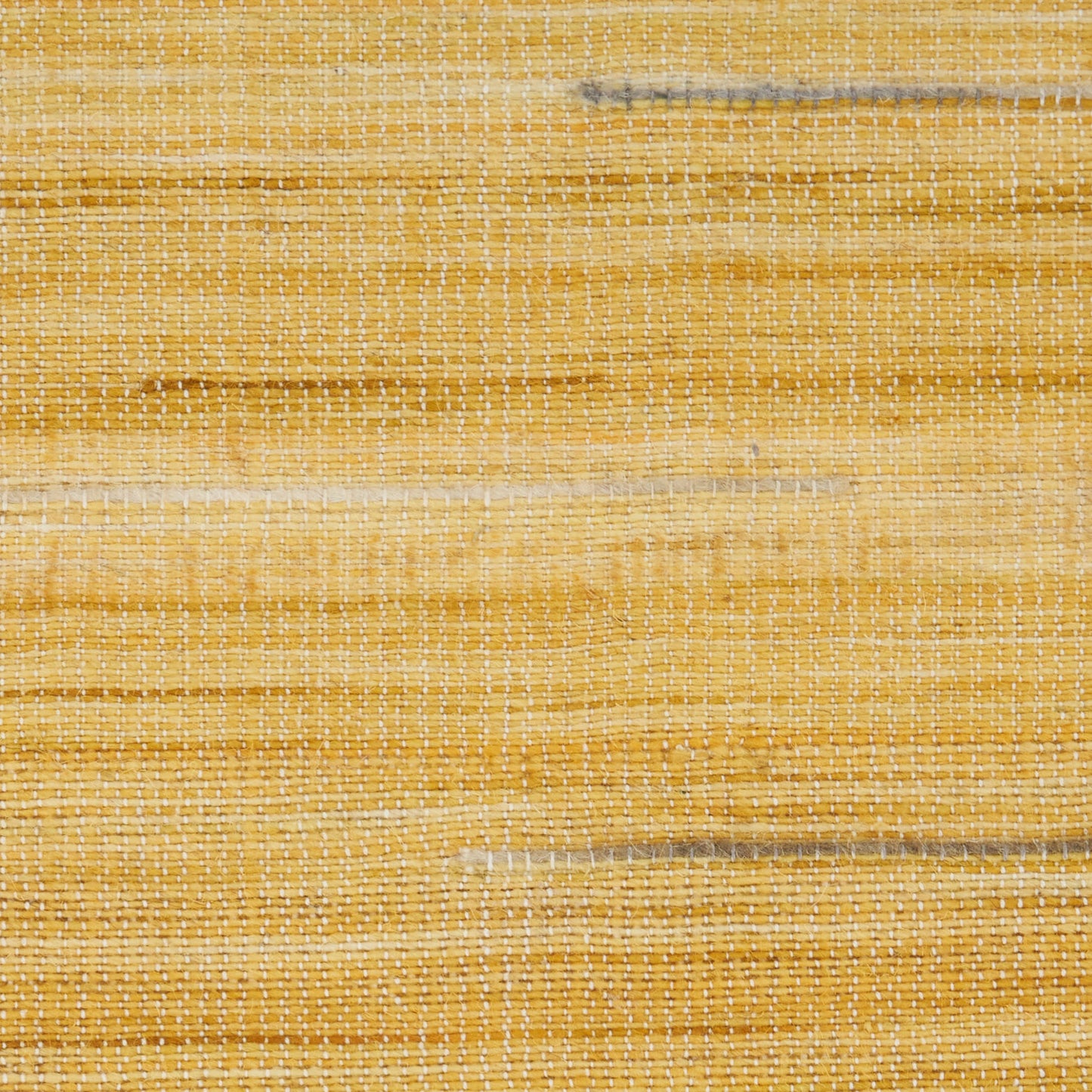 Close-up of yellow woven raffia texture with horizontal stripes; rustic mat/basket material for home decor.