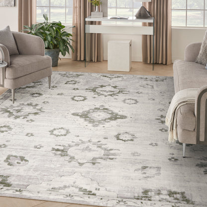 Light gray oriental-style area rug with muted sage-green floral medallions in a contemporary living room.