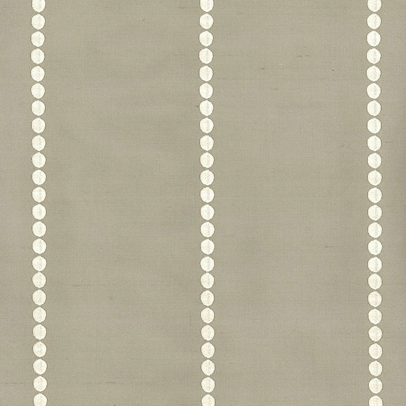 Dove-colored woven rug with subtle embroidery pattern.
