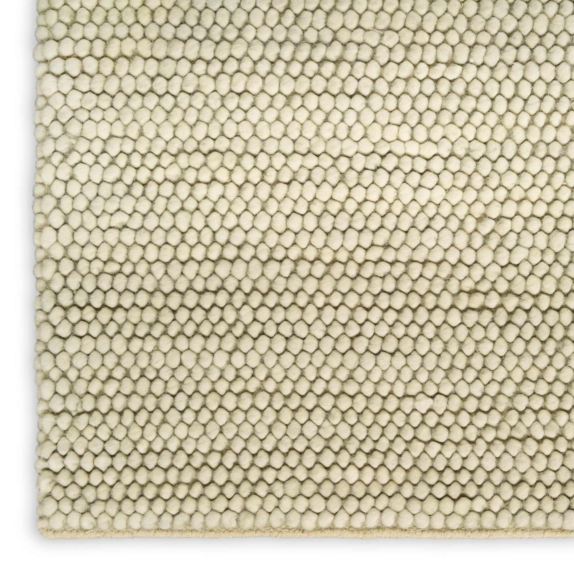 Cream boucle rug close-up with tiny rounded pile loops and plush textured surface.