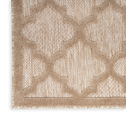 Beige woven rug with taupe geometric trellis pattern and textured border; close-up corner.