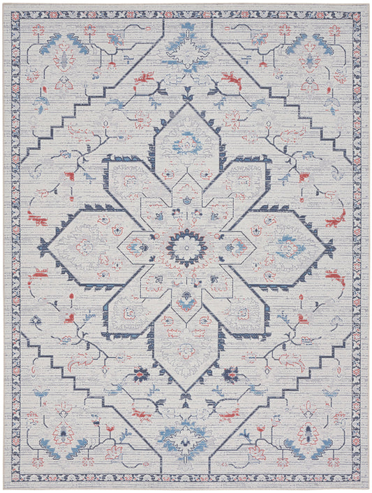 Gray-blue Persian-style area rug with central star medallion, navy outlines, blue and red florals, and a patterned border.
