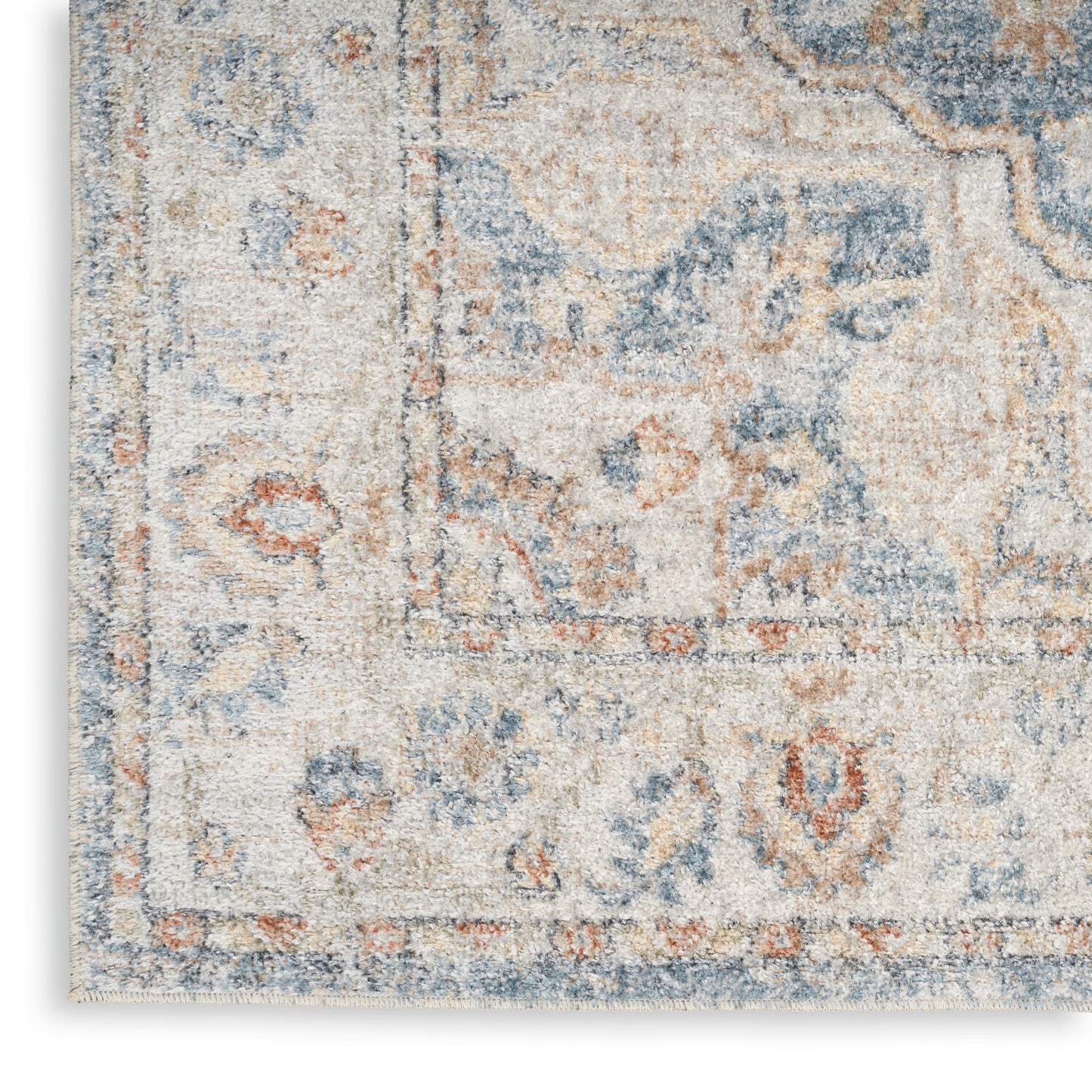 Blue, beige & rust oriental area rug with a distressed woven texture & decorative border.