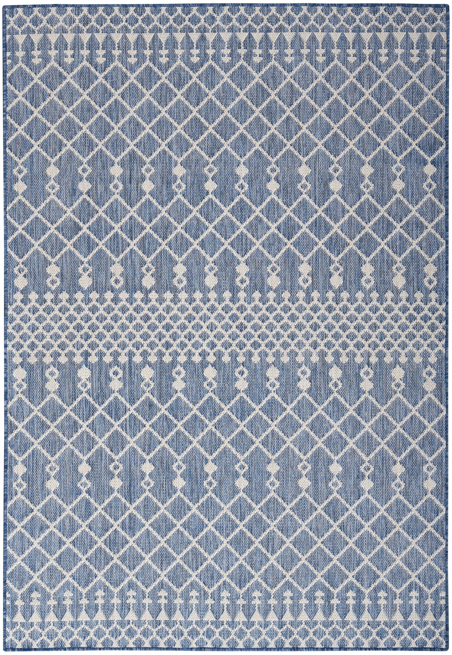 Rectangular blue and white woven rug with geometric diamond lattice and dotted bands.