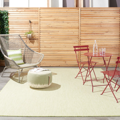 Outdoor rug laid on a patio.