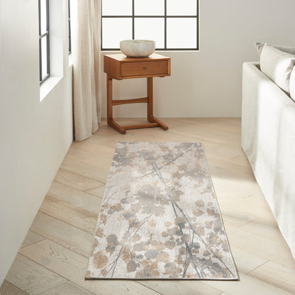 Neutral floral runner rug on light wood floor beside a small wooden side table with a white ceramic bowl.