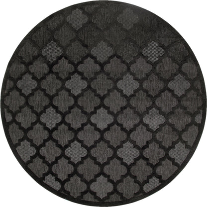 Round black rug with a gray quatrefoil lattice pattern, textured fabric for decorative floor.