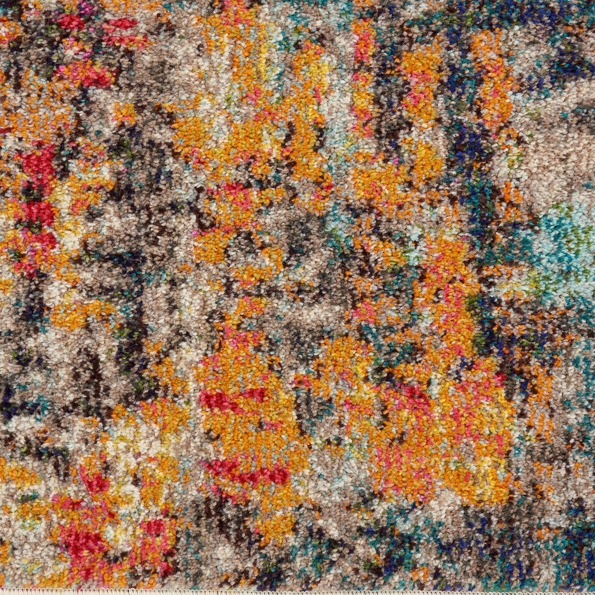 Colorful abstract shag rug with orange, yellow, pink, turquoise and brown tones in a dense tufted pile.