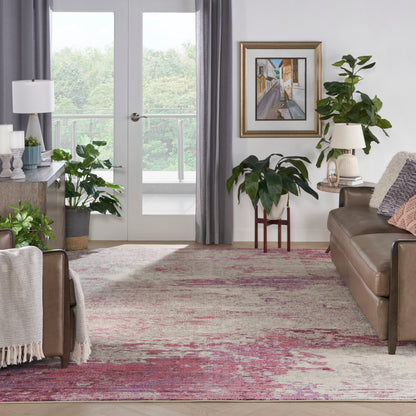 Cozy living room with brown leather sofa, green potted plants, framed art, and pink-beige patterned rug.