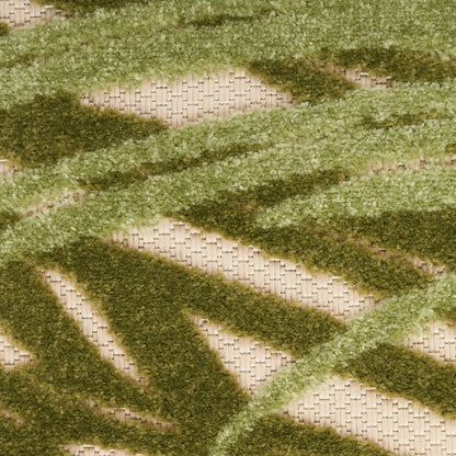 Outdoor shag rug with moss and olive green zigzag stripes on a beige woven base.