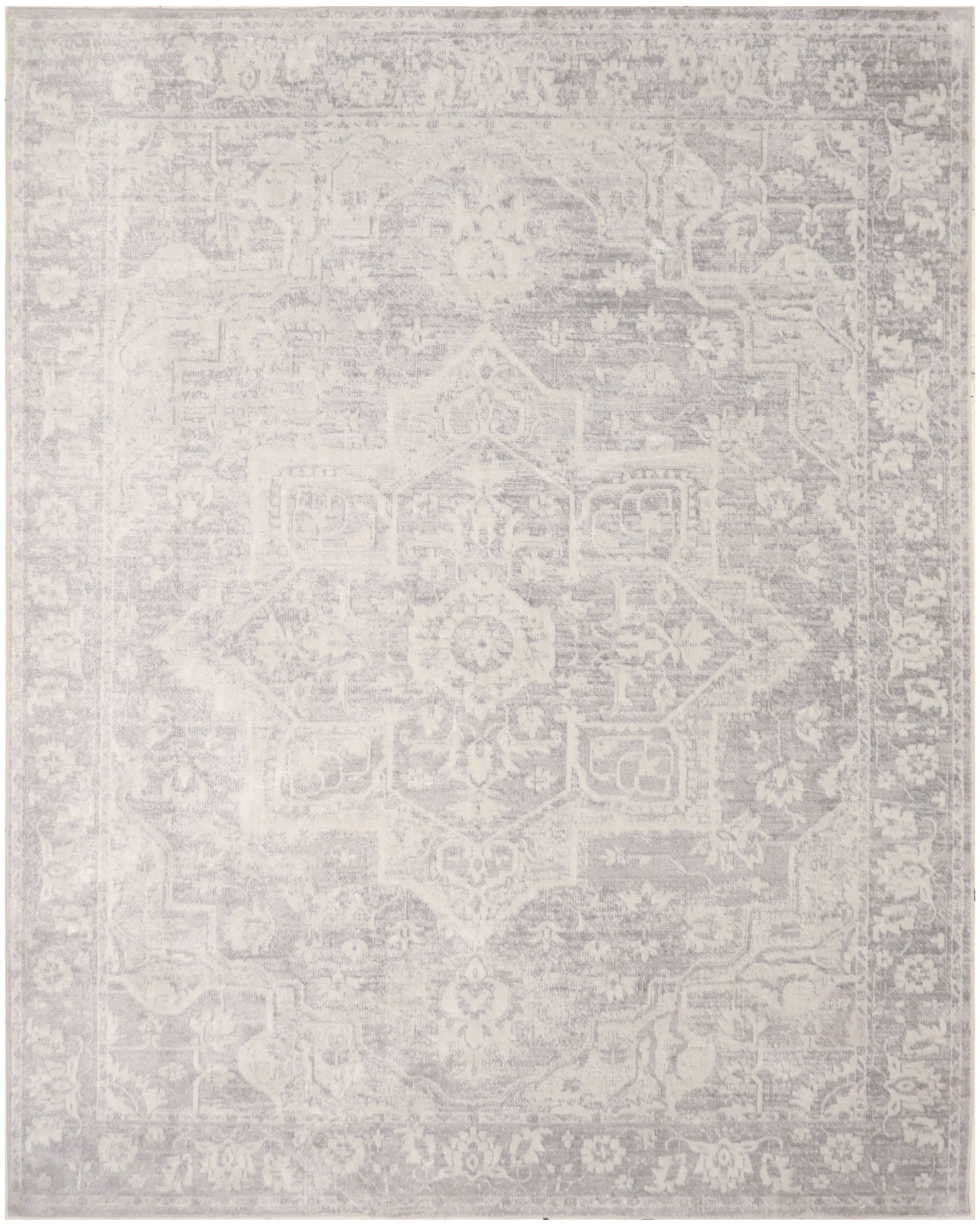 Ivory-gray distressed oriental rug with central medallion and ornate border, soft faded finish.