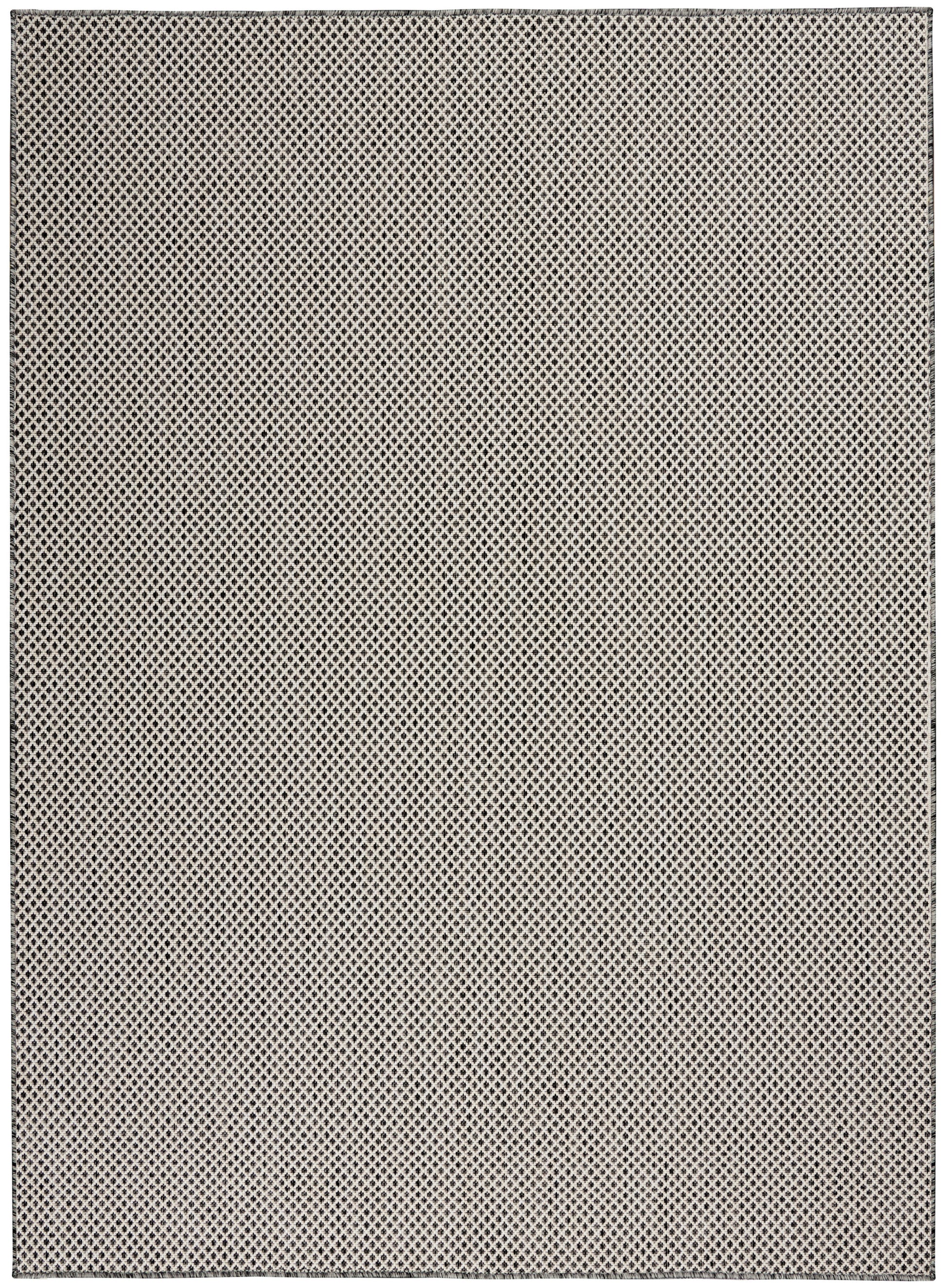 Beige flat-weave rug with a tiny black diamond lattice pattern.