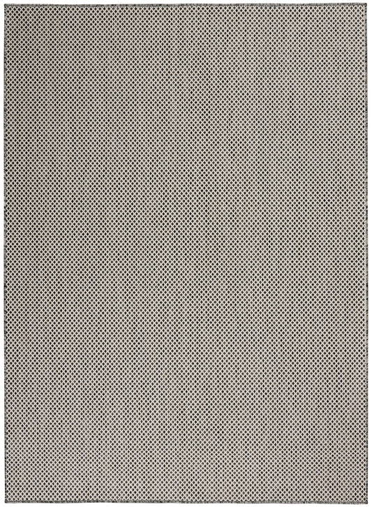Beige flat-weave rug with a tiny black diamond lattice pattern.