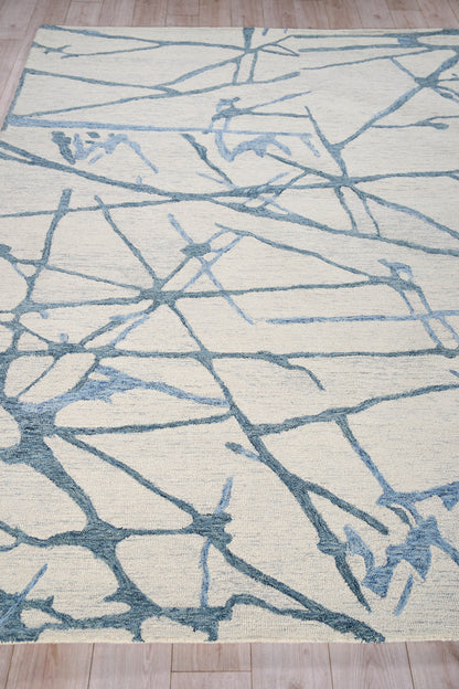 Rectangular cream area rug with a light blue abstract branch pattern for modern living spaces.