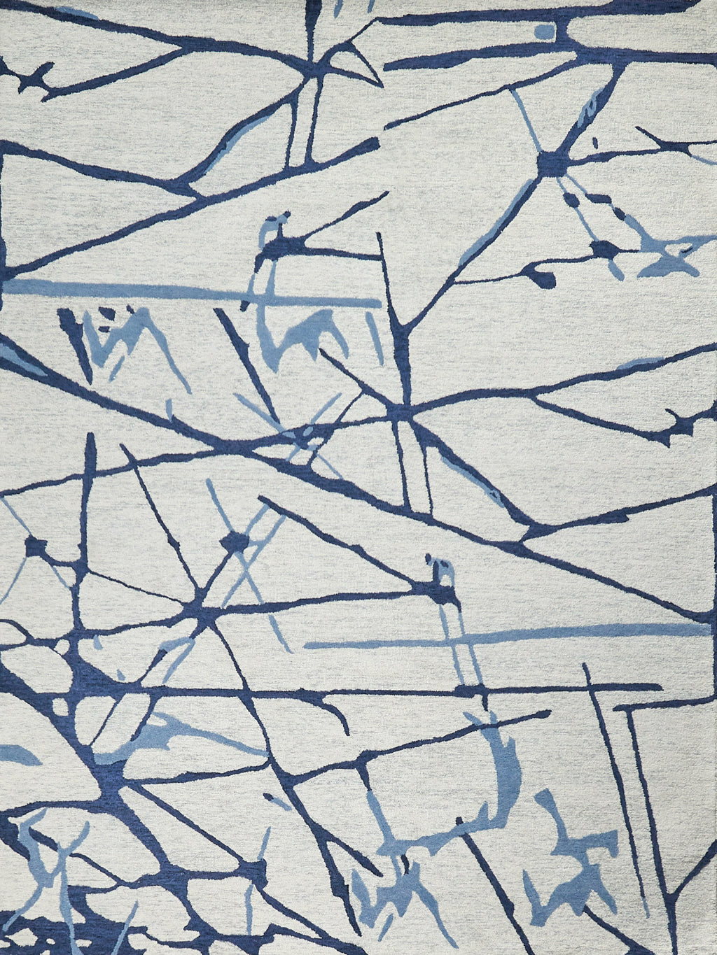 Abstract area rug with navy and light-blue branch-like lines on a light gray background.