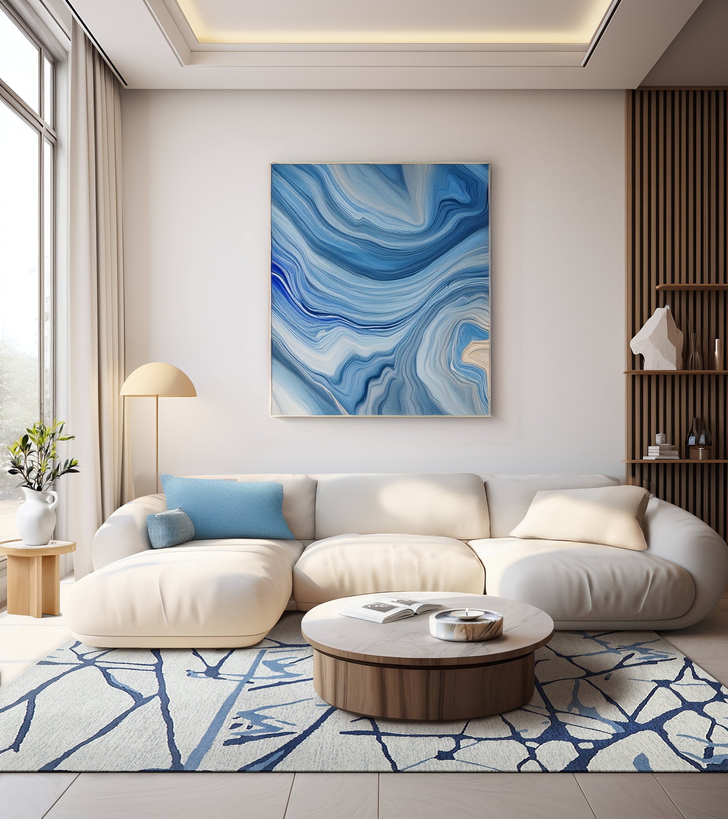 Modern living room with a white curved sectional, blue cushions, round wood coffee table, blue abstract wall art, rug.