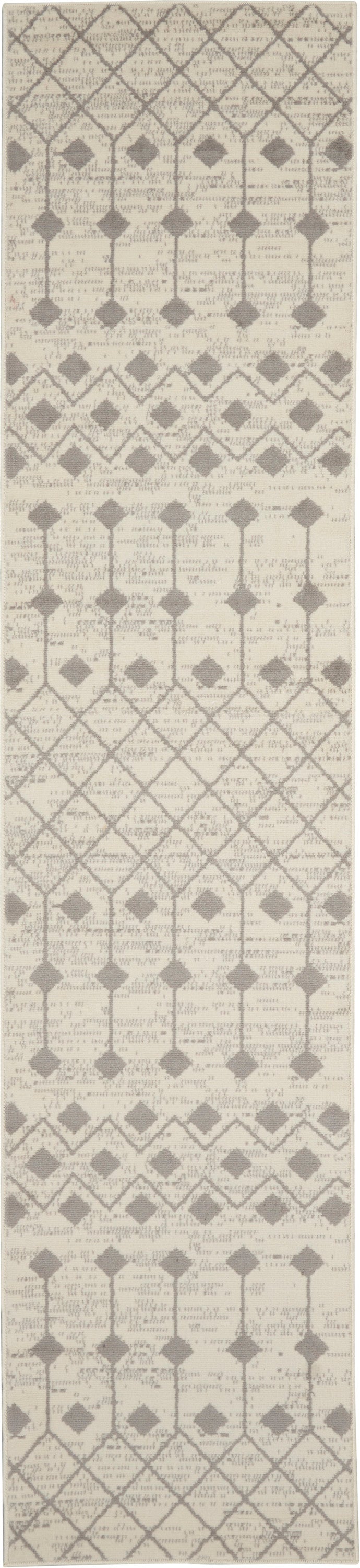 Cream and taupe geometric runner rug with lattice, diamond and arch motifs in a repeating pattern.
