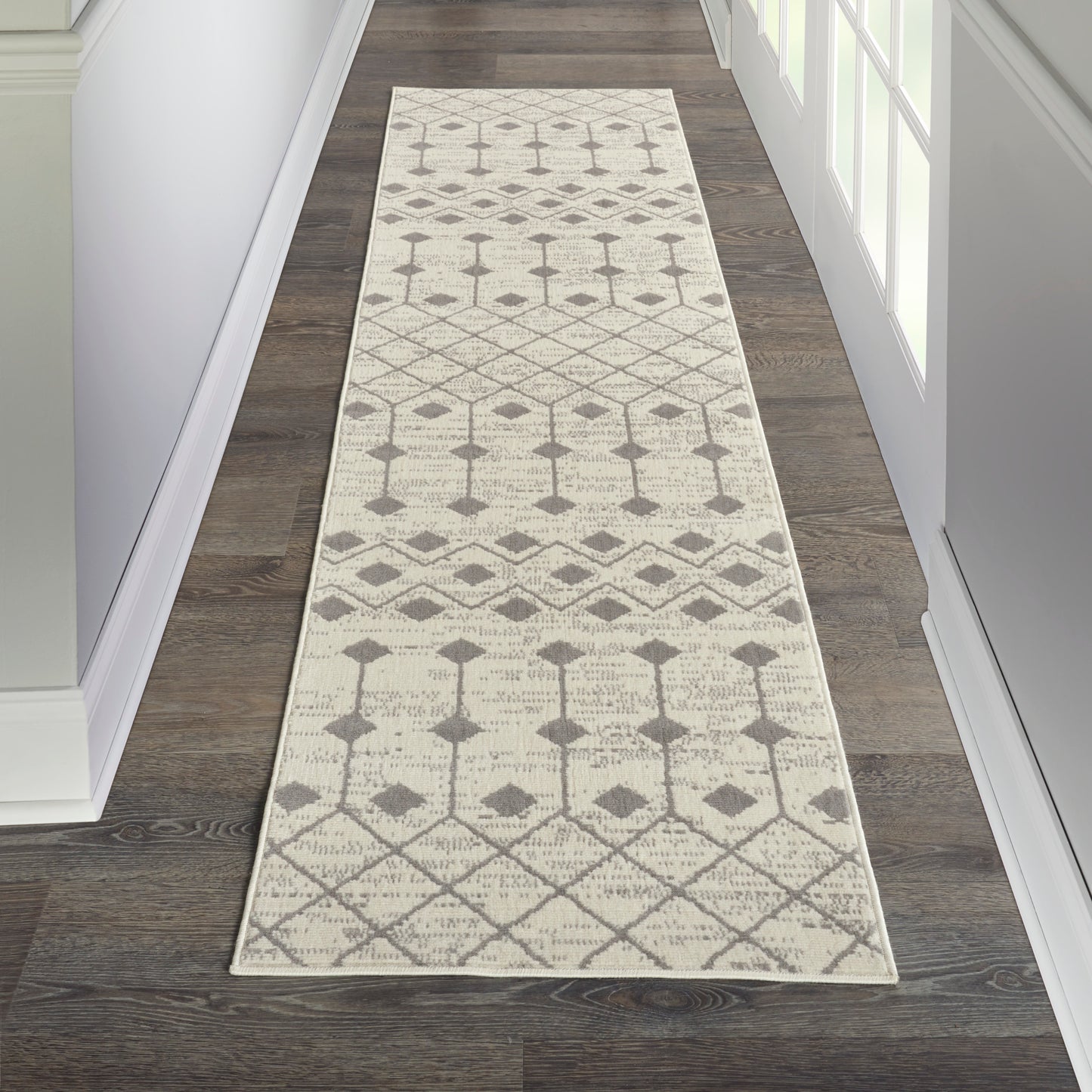 Ivory hallway runner rug with gray geometric diamonds and trellis pattern; neutral woven design for entryways.